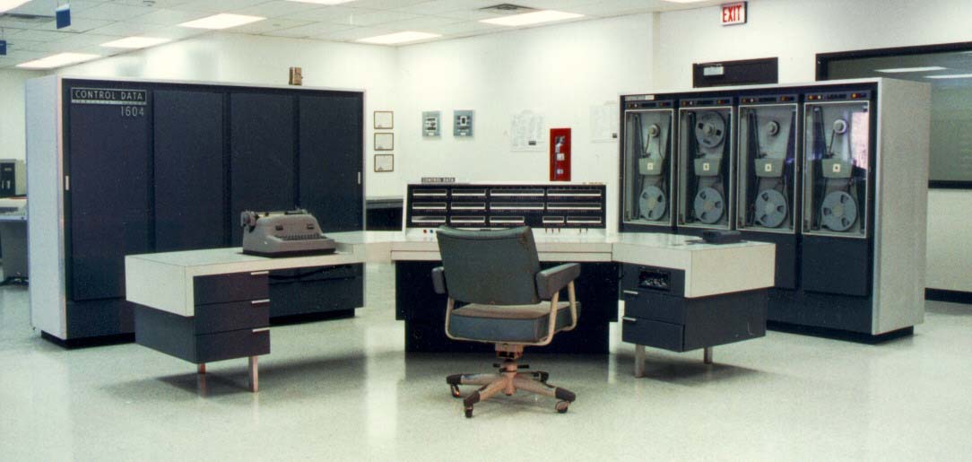 The CDC 1604 computer system with a large central console and tape drives.